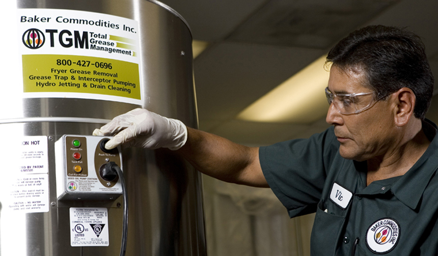a man is working on a machine that says baker commodities inc.