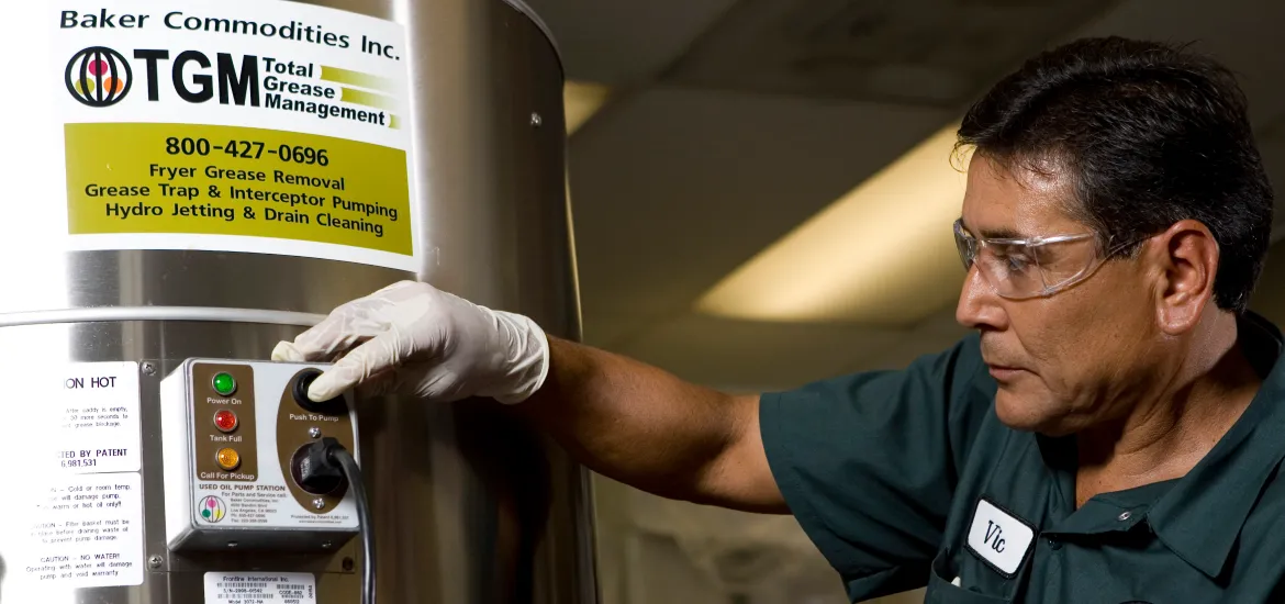 A technician manages fryer grease removal with the Total Grease Management system.
