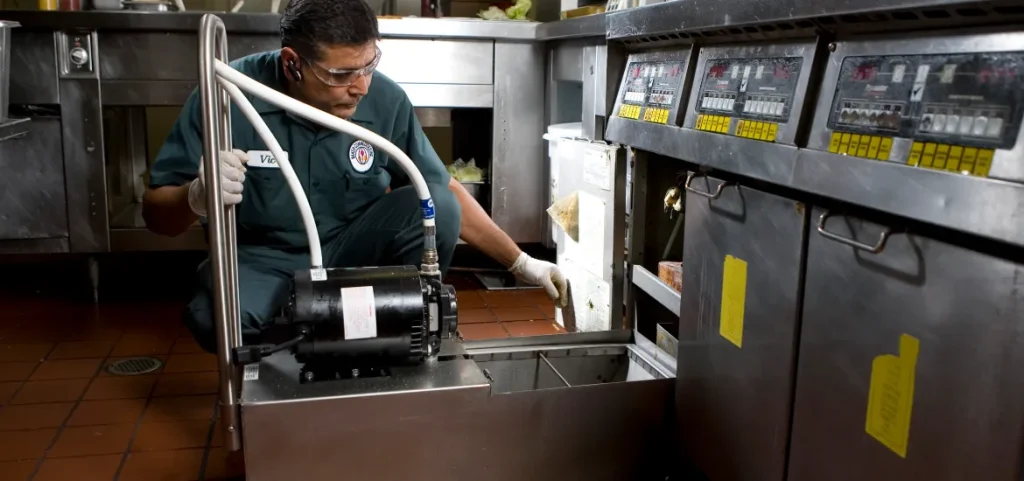 A Baker Commodities technician handles used cooking oil pickup from a restaurant.
